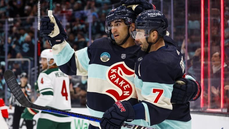 Feb 24, 2024; Seattle, Washington, USA; Seattle Kraken right wing Jordan Eberle (7) celebrates with center Matty Beniers (10) after scoring a goal against the Minnesota Wild during the third period at Climate Pledge Arena. Mandatory Credit: Joe Nicholson-USA TODAY Sports
