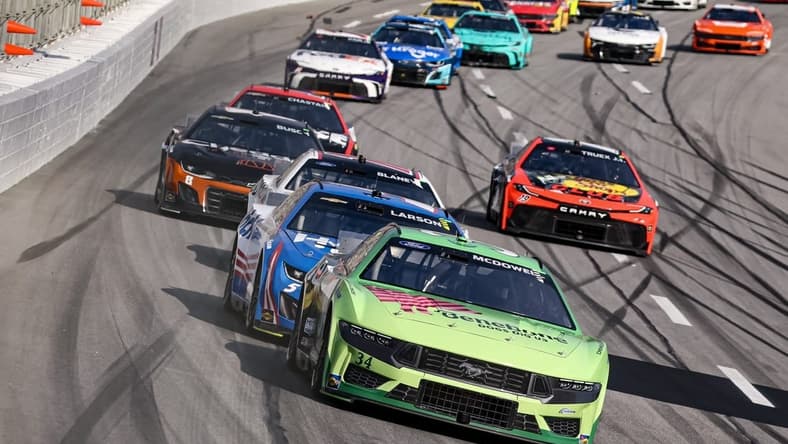 Feb 25, 2024; Hampton, Georgia, USA; NASCAR Cup Series driver Michael McDowell (34) battles with NASCAR Cup Series driver Kyle Larson (5) during the Ambetter Health 400 at Atlanta Motor Speedway. Mandatory Credit: David Yeazell-USA TODAY Sports