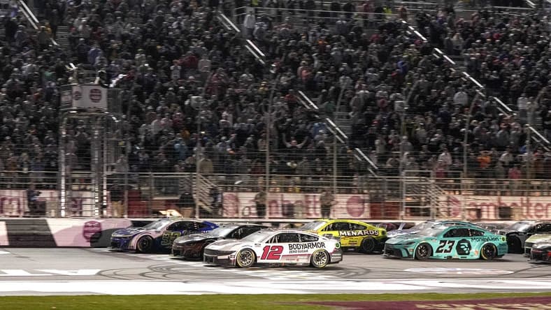 Feb 25, 2024; Hampton, Georgia, USA; NASCAR Cup Series driver Daniel Suarez (99) (near wall) beats NASCAR Cup Series driver Ryan Blaney (12) to the line to win the Ambetter Health 400 at Atlanta Motor Speedway. Mandatory Credit: David Yeazell-USA TODAY Sports