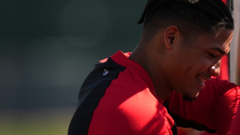 Cincinnati Reds shortstop Noelvi Marte (16) smiles while waiting for his turn to take batting practice during spring training workouts, Thursday, Feb. 15, 2024, at the team s spring training facility in Goodyear, Ariz.
