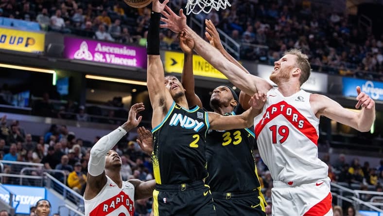 Feb 26, 2024; Indianapolis, Indiana, USA; Indiana Pacers guard Andrew Nembhard (2) shoots the ball while Toronto Raptors center Jakob Poeltl (19) defends in the second half at Gainbridge Fieldhouse. Mandatory Credit: Trevor Ruszkowski-USA TODAY Sports