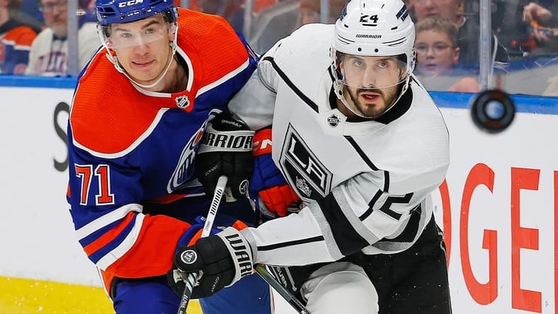 Feb 26, 2024; Edmonton, Alberta, CAN; Edmonton Oilers forward Ryan McLeod (71) and Los Angeles Kings forward Phillip Danault (24) follow a loose puck during the second period at Rogers Place. Mandatory Credit: Perry Nelson-USA TODAY Sports