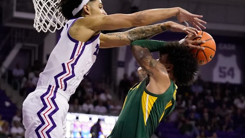 Feb 26, 2024; Fort Worth, Texas, USA; TCU Horned Frogs guard Micah Peavy (0) defends Baylor Bears forward Jalen Bridges (11) during the second half at Ed and Rae Schollmaier Arena. Mandatory Credit: Raymond Carlin III-USA TODAY Sports