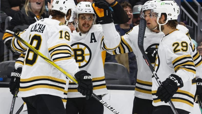 Feb 26, 2024; Seattle, Washington, USA; Boston Bruins right wing David Pastrnak (88, middle) celebrates with teammates after scoring a goal against the Seattle Kraken during the second period at Climate Pledge Arena. Mandatory Credit: Joe Nicholson-USA TODAY Sports