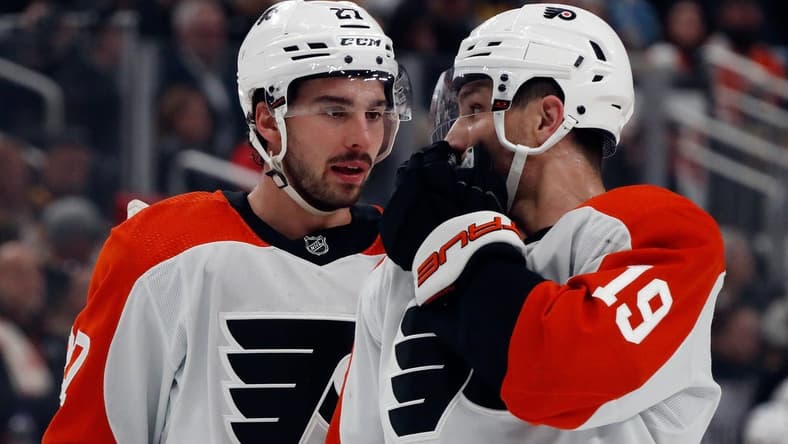 Feb 25, 2024; Pittsburgh, Pennsylvania, USA; Philadelphia Flyers left wing Noah Cates (27) and right wing Garnet Hathaway (19) talk before a face-off against the Pittsburgh Penguins during the first period at PPG Paints Arena. Mandatory Credit: Charles LeClaire-USA TODAY Sports