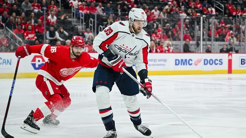 Feb 27, 2024; Detroit, Michigan, USA; Washington Capitals right wing Anthony Mantha (39) brings the puck up ice against Detroit Red Wings defenseman Jake Walman (96) during the first period at Little Caesars Arena. Mandatory Credit: Tim Fuller-USA TODAY Sports