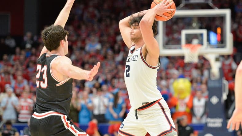 Feb 27, 2024; Dayton, Ohio, USA; Dayton Flyers forward Nate Santos (2) passes the ball against Davidson Wildcats guard Connor Kochera (23) during the second half of the game at University of Dayton Arena. Mandatory Credit: Matt Lunsford-USA TODAY Sports