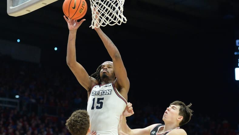 Feb 27, 2024; Dayton, Ohio, USA; Dayton Flyers forward DaRon Holmes II (15) shoots the ball against Davidson Wildcats guard Achile Spadone (3) and forward Sean Logan (15) during the second half of the game at University of Dayton Arena. Mandatory Credit: Matt Lunsford-USA TODAY Sports