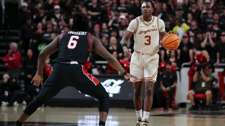 Feb 27, 2024; Lubbock, Texas, USA;  UT Longhorns guard Max Abmas (3) dribbles the ball against Texas Tech Red Raiders guard Joe Toussaint (6) in the first half at United Supermarkets Arena. Mandatory Credit: Michael C. Johnson-USA TODAY Sports