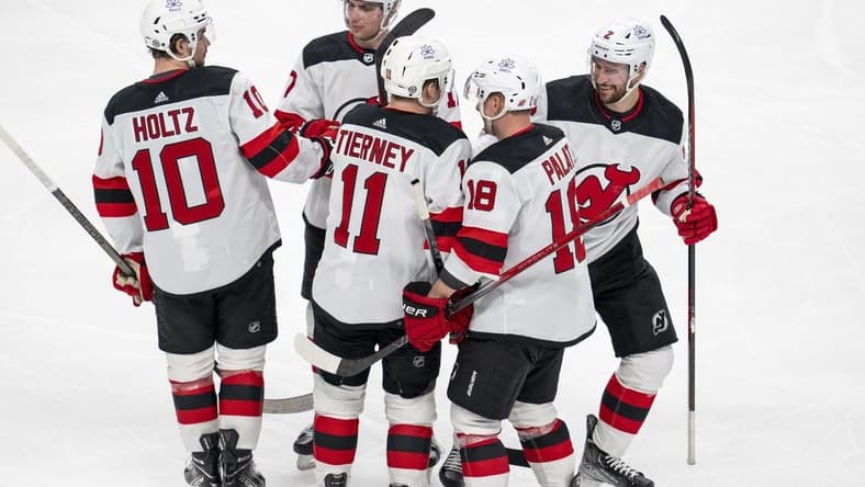 Feb 27, 2024; San Jose, California, USA;  New Jersey Devils right wing Alexander Holtz (10) and center Chris Tierney (11) and left wing Ondrej Palat (18) and defenseman Brendan Smith (2) and defenseman Simon Nemec (17) celebrate after the goal against the San Jose Sharks during the third period at SAP Center at San Jose. Mandatory Credit: Neville E. Guard-USA TODAY Sports