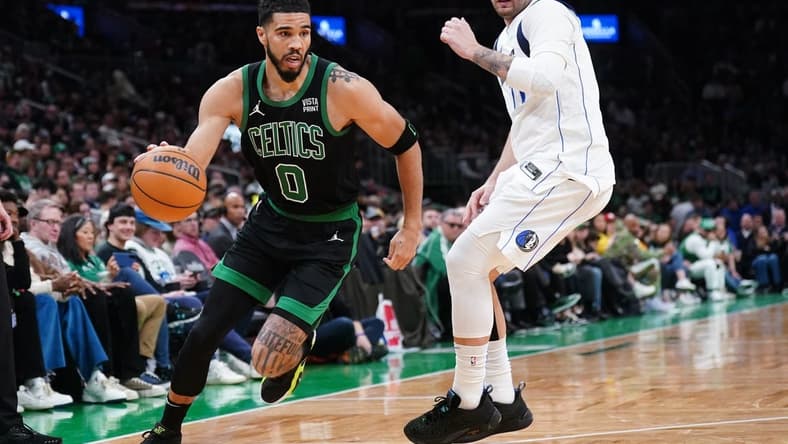 Mar 1, 2024; Boston, Massachusetts, USA; Boston Celtics forward Jayson Tatum (0) drives the ball against Dallas Mavericks guard Luka Doncic (77) in the second half at TD Garden. Mandatory Credit: David Butler II-USA TODAY Sports