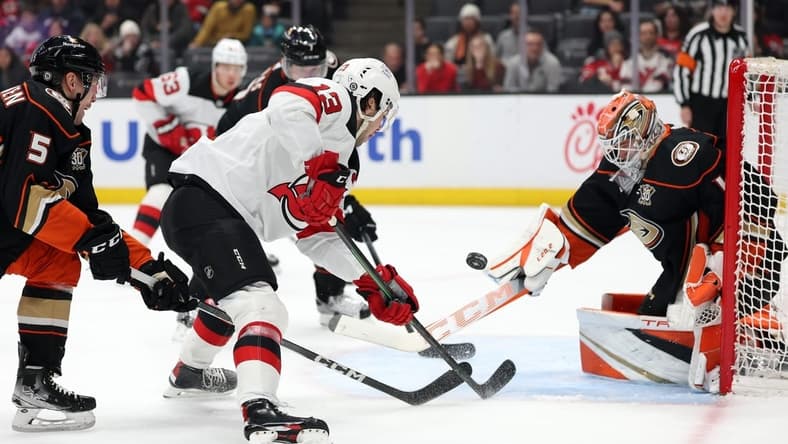 Mar 1, 2024; Anaheim, California, USA; New Jersey Devils center Nico Hischier (13) shoots the puck against Anaheim Ducks goaltender Lukas Dostal (1) during the first period at Honda Center. Mandatory Credit: Kiyoshi Mio-USA TODAY Sports
