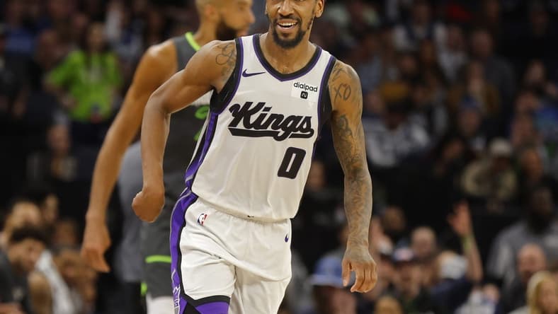 Mar 1, 2024; Minneapolis, Minnesota, USA; Sacramento Kings guard Malik Monk (0) celebrates his three-point basket against the Minnesota Timberwolves in overtime at Target Center. Mandatory Credit: Bruce Kluckhohn-USA TODAY Sports