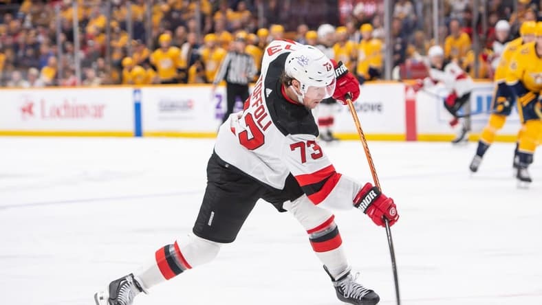 Feb 13, 2024; Nashville, Tennessee, USA; New Jersey Devils right wing Tyler Toffoli (73) takes a shot on goal against the Nashville Predators during the second period at Bridgestone Arena. Mandatory Credit: Steve Roberts-USA TODAY Sports