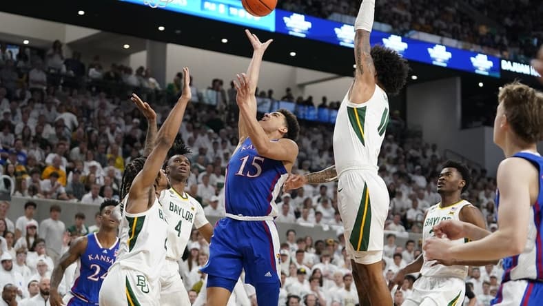 Mar 2, 2024; Waco, Texas, USA; Kansas Jayhawks guard Kevin McCullar Jr. (15) shoots over Baylor Bears guard Jayden Nunn (2) during the first half at Paul and Alejandra Foster Pavilion. Mandatory Credit: Raymond Carlin III-USA TODAY Sports