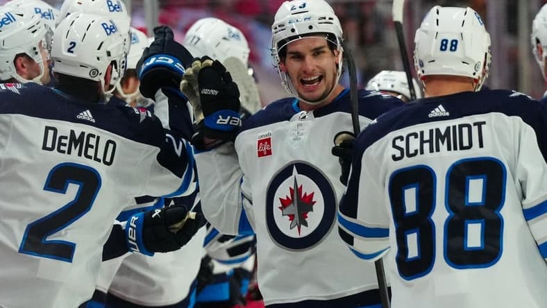 Mar 2, 2024; Raleigh, North Carolina, USA; Winnipeg Jets center Sean Monahan (23) is congratulated after his goal against the Carolina Hurricanes during the third period at PNC Arena. Mandatory Credit: James Guillory-USA TODAY Sports