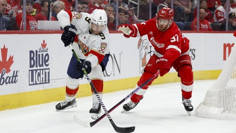 Mar 2, 2024; Detroit, Michigan, USA; Florida Panthers center Sam Bennett (9) and Detroit Red Wings left wing J.T. Compher (37) battle for the puck in the first period at Little Caesars Arena. Mandatory Credit: Rick Osentoski-USA TODAY Sports