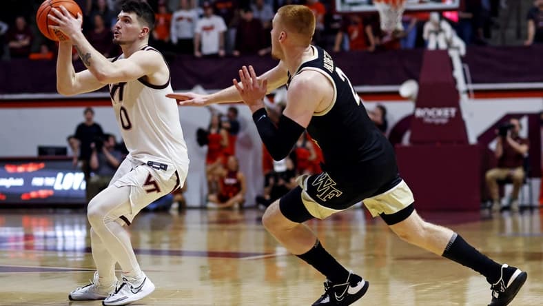 Mar 2, 2024; Blacksburg, Virginia, USA; Virginia Tech Hokies guard Hunter Cattoor (0) shoots the ball against Wake Forest Demon Deacons guard Cameron Hildreth (2) during the second half at Cassell Coliseum. Mandatory Credit: Peter Casey-USA TODAY Sports