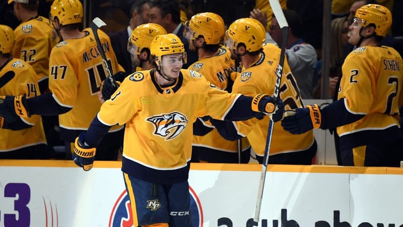 Mar 2, 2024; Nashville, Tennessee, USA; Nashville Predators center Cody Glass (8) celebrates with his teammates after a goal during the second period against the Colorado Avalanche at Bridgestone Arena. Mandatory Credit: Christopher Hanewinckel-USA TODAY Sports