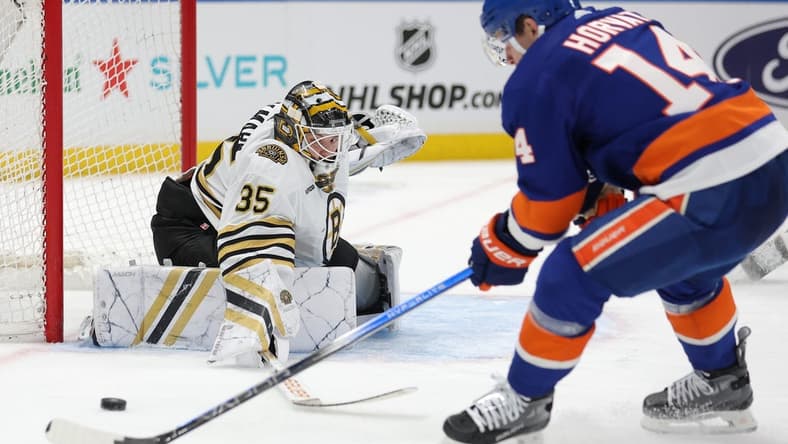 Mar 2, 2024; Elmont, New York, USA; Boston Bruins goaltender Linus Ullmark (35) makes a save against New York Islanders center Bo Horvat (14) during the second period at UBS Arena. Mandatory Credit: Brad Penner-USA TODAY Sports