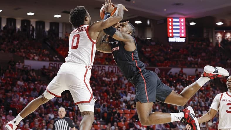 Mar 2, 2024; Norman, Oklahoma, USA; Houston Cougars guard Jamal Shead (1) and Oklahoma Sooners guard Le'Tre Darthard (0) reach for a loose ball during the first half at Lloyd Noble Center. Mandatory Credit: Alonzo Adams-USA TODAY Sports