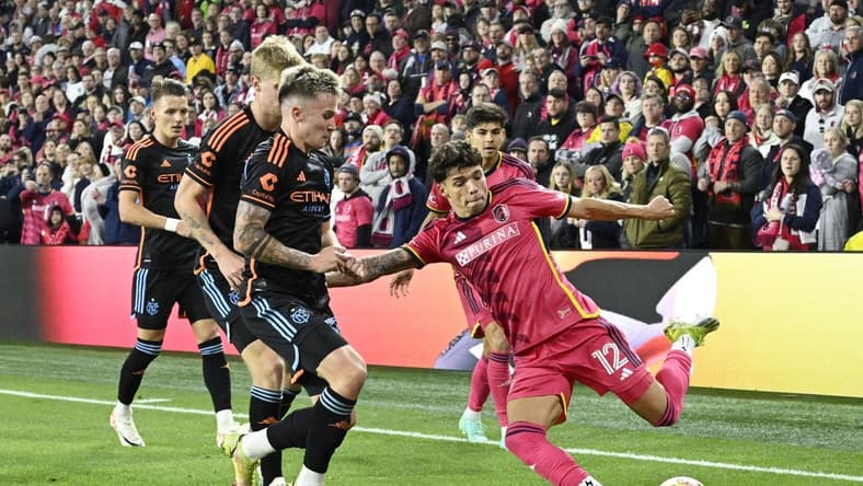 Mar 2, 2024; St. Louis, Missouri, USA; St. Louis CITY SC midfielder Celio Pompeu (12) controls the ball against New York City FC defender Mitja Ilenic (35) in the first half at CITYPARK. Mandatory Credit: Jeff Le-USA TODAY Sports