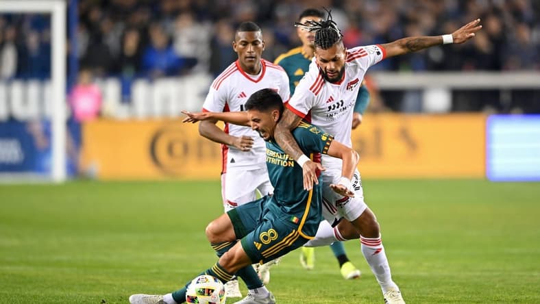 Mar 2, 2024; San Jose, California, USA; San Jose Earthquakes forward Will Richmond (20) battles for the ball against LA Galaxy midfielder Mark Delgado (8) during the first half at PayPal Park. Mandatory Credit: Robert Edwards-USA TODAY Sports
