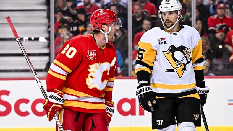 Mar 2, 2024; Calgary, Alberta, CAN; Calgary Flames center Blake Coleman (20) opposes a penalty call while Pittsburgh Penguins defenseman Erik Karlsson (65) looks on during the third period at Scotiabank Saddledome. Mandatory Credit: Brett Holmes-USA TODAY Sports