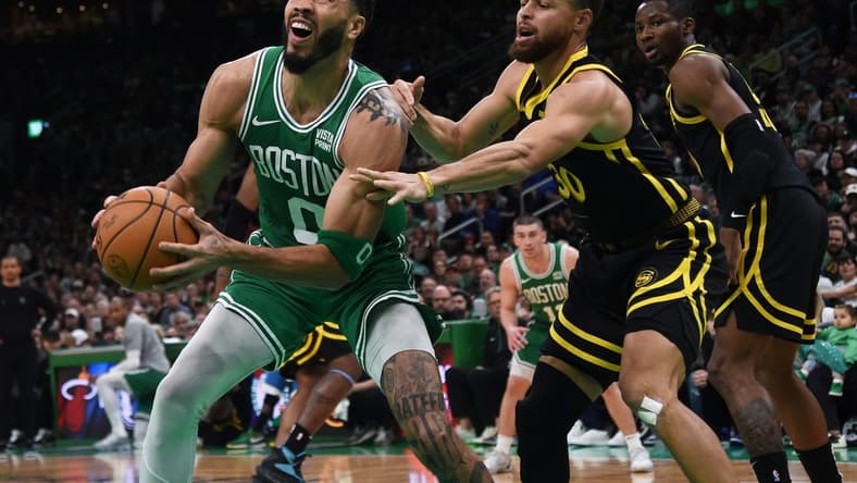 Mar 3, 2024; Boston, Massachusetts, USA;  Boston Celtics forward Jayson Tatum (0) controls the ball while Golden State Warriors guard Stephen Curry (30) defends during the first half at TD Garden. Mandatory Credit: Bob DeChiara-USA TODAY Sports