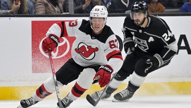Mar 3, 2024; Los Angeles, California, USA; New Jersey Devils left wing Jesper Bratt (63) keeps the puck away from Los Angeles Kings center Phillip Danault (24) in the second period at Crypto.com Arena. Mandatory Credit: Jayne Kamin-Oncea-USA TODAY Sports