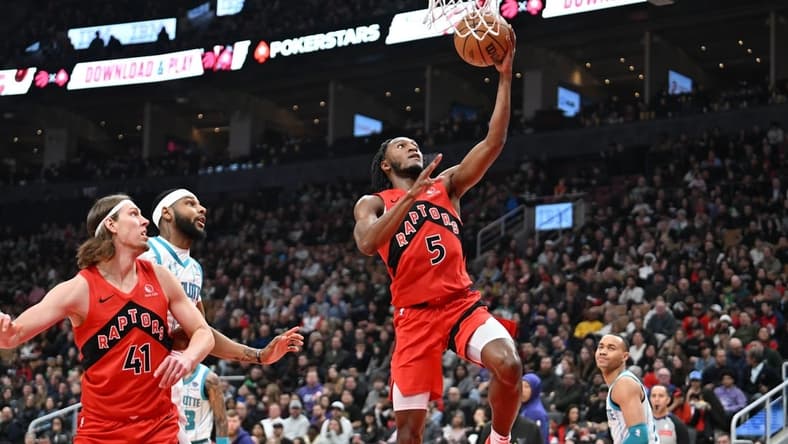 Mar 3, 2024; Toronto, Ontario, CAN; Toronto Raptors guard Immanuel Quickley (5) scores on a layup against the Charlotte Hornets in the first half at Scotiabank Arena. Mandatory Credit: Dan Hamilton-USA TODAY Sports