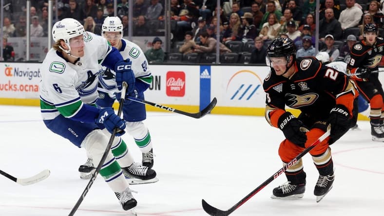Mar 3, 2024; Anaheim, California, USA; Vancouver Canucks right wing Brock Boeser (6) shoots against Anaheim Ducks defenseman Gustav Lindstrom (28) during the first period at Honda Center. Mandatory Credit: Jason Parkhurst-USA TODAY Sports