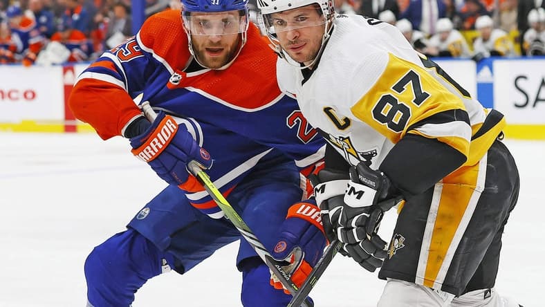 Mar 3, 2024; Edmonton, Alberta, CAN; Edmonton Oilers forward Leon Draisaitl (29) and Pittsburgh Penguins forward Sidney Crosby (87) look for a loose puck during the first period at Rogers Place. Mandatory Credit: Perry Nelson-USA TODAY Sports