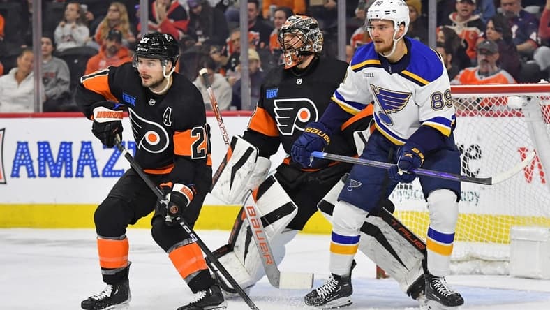 Mar 4, 2024; Philadelphia, Pennsylvania, USA; Philadelphia Flyers center Scott Laughton (21) and goaltender Samuel Ersson (33) battle for position with St. Louis Blues left wing Pavel Buchnevich (89) during the first period at Wells Fargo Center. Mandatory Credit: Eric Hartline-USA TODAY Sports
