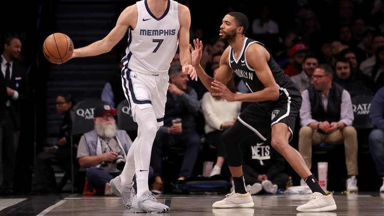 Mar 4, 2024; Brooklyn, New York, USA; Memphis Grizzlies forward Santi Aldama (7) controls the ball against Brooklyn Nets forward Mikal Bridges (1) during the first quarter at Barclays Center. Mandatory Credit: Brad Penner-USA TODAY Sports