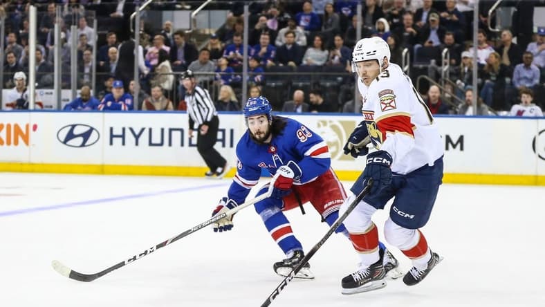 Mar 4, 2024; New York, New York, USA; New York Rangers center Mika Zibanejad (93) and Florida Panthers center Sam Reinhart (13) chases the puck in the first period at Madison Square Garden. Mandatory Credit: Wendell Cruz-USA TODAY Sports