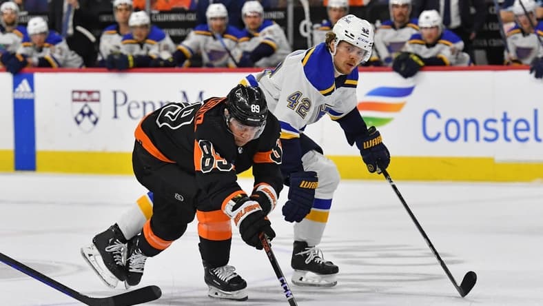 Mar 4, 2024; Philadelphia, Pennsylvania, USA; Philadelphia Flyers right wing Cam Atkinson (89) ands St. Louis Blues right wing Kasperi Kapanen (42) battle for the puck during the second period at Wells Fargo Center. Mandatory Credit: Eric Hartline-USA TODAY Sports
