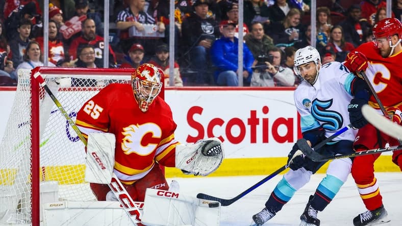 Mar 4, 2024; Calgary, Alberta, CAN; Calgary Flames goaltender Jacob Markstrom (25) makes a save against the Seattle Kraken during the first period at Scotiabank Saddledome. Mandatory Credit: Sergei Belski-USA TODAY Sports