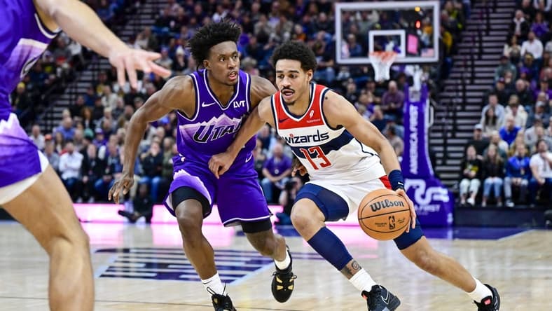 Mar 4, 2024; Salt Lake City, Utah, USA; Washington Wizards guard Jordan Poole (13) drives around Utah Jazz guard Collin Sexton (2) during the first half at the Delta Center. Mandatory Credit: Christopher Creveling-USA TODAY Sports