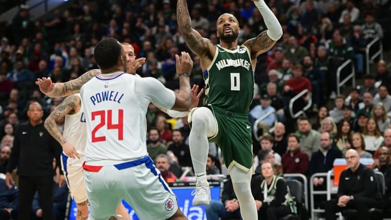 Mar 4, 2024; Milwaukee, Wisconsin, USA; Milwaukee Bucks guard Damian Lillard (0) takes a shot against Los Angeles Clippers guard Norman Powell (24) in the third quarter at Fiserv Forum. Mandatory Credit: Benny Sieu-USA TODAY Sports