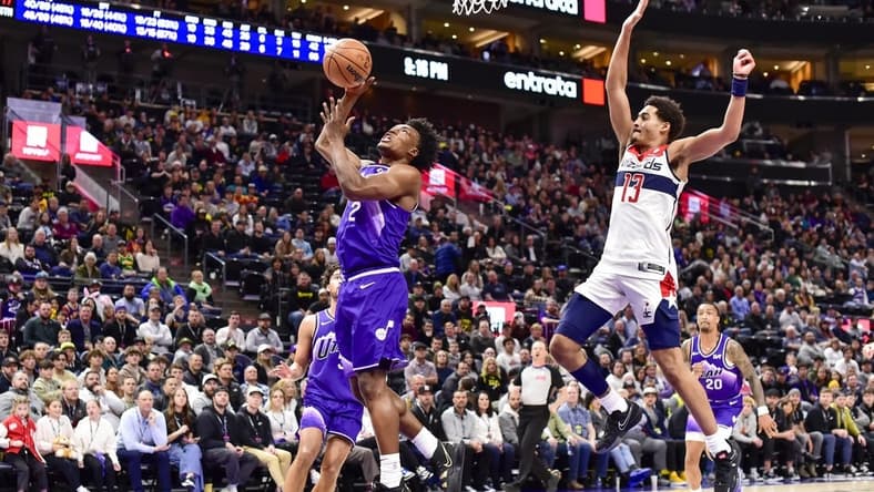 Mar 4, 2024; Salt Lake City, Utah, USA; Utah Jazz guard Collin Sexton (2) takes a shot around Washington Wizards guard Jordan Poole (13) during the second half at the Delta Center. Mandatory Credit: Christopher Creveling-USA TODAY Sports