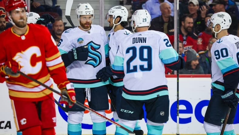 Mar 4, 2024; Calgary, Alberta, CAN; Seattle Kraken defenseman Adam Larsson (6) celebrates his goal with teammates against the Calgary Flames during the third period at Scotiabank Saddledome. Mandatory Credit: Sergei Belski-USA TODAY Sports
