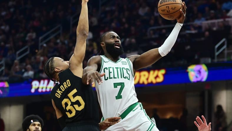 Mar 5, 2024; Cleveland, Ohio, USA;  Boston Celtics guard Jaylen Brown (7) drives to the basket against Cleveland Cavaliers forward Isaac Okoro (35) during the first half at Rocket Mortgage FieldHouse. Mandatory Credit: Ken Blaze-USA TODAY Sports