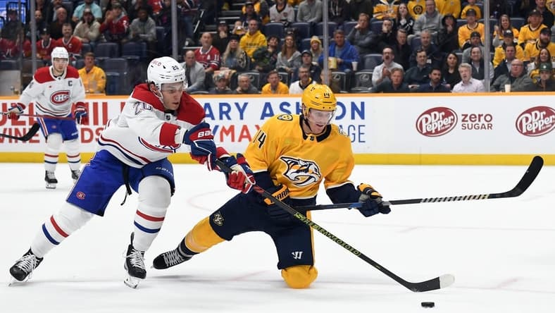 Mar 5, 2024; Nashville, Tennessee, USA; Nashville Predators center Gustav Nyquist (14) is played off the puck by Montreal Canadiens left wing Juraj Slafkovsky (20) during the first period at Bridgestone Arena. Mandatory Credit: Christopher Hanewinckel-USA TODAY Sports