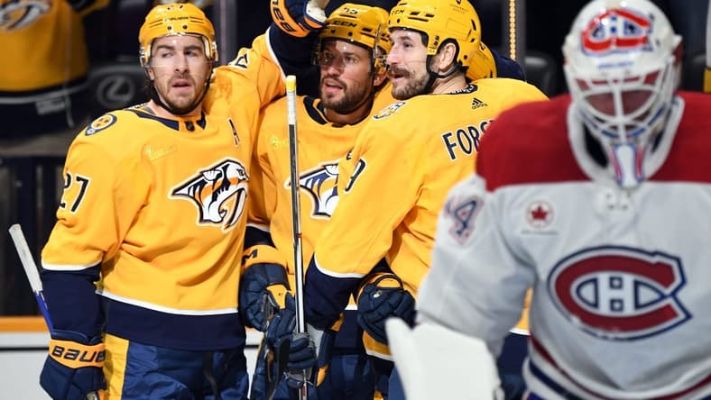 Mar 5, 2024; Nashville, Tennessee, USA; Nashville Predators left wing Filip Forsberg (9) celebrates with teammates after a goal against Montreal Canadiens goaltender Jake Allen (34) during the first period at Bridgestone Arena. Mandatory Credit: Christopher Hanewinckel-USA TODAY Sports