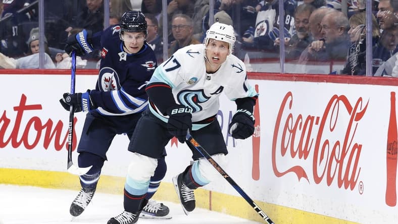 Mar 5, 2024; Winnipeg, Manitoba, CAN; Winnipeg Jets center Vladislav Namestnikov (7) and Seattle Kraken center Jaden Schwartz (17) chase after the puck in the first period at Canada Life Centre. Mandatory Credit: James Carey Lauder-USA TODAY Sports