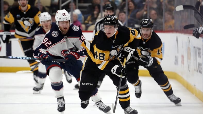 Mar 5, 2024; Pittsburgh, Pennsylvania, USA; Pittsburgh Penguins right wing Valtteri Puustinen (48) skates with the puck against the Columbus Blue Jackets during the third period at PPG Paints Arena. The Penguins won 5-3. Mandatory Credit: Charles LeClaire-USA TODAY Sports