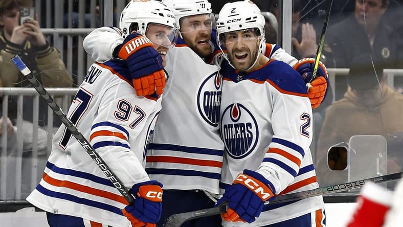 Mar 5, 2024; Boston, Massachusetts, USA; Edmonton Oilers center Leon Draisaitl (29) celebrates his game winning overtime goal against the Boston Bruins with teammates center Connor McDavid (97) and defenseman Evan Bouchard (2) at TD Garden. Mandatory Credit: Winslow Townson-USA TODAY Sports