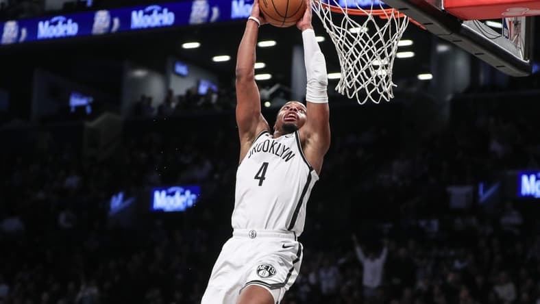 Mar 5, 2024; Brooklyn, New York, USA; Brooklyn Nets guard Dennis Smith Jr. (4) goes up for a dunk in the fourth quarter against the Philadelphia 76ers at Barclays Center. Mandatory Credit: Wendell Cruz-USA TODAY Sports