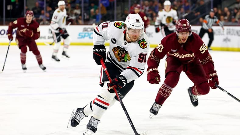 Mar 5, 2024; Tempe, Arizona, USA; Chicago Blackhawks left wing Anthony Beauvillier (91) moves the puck against Arizona Coyotes defenseman Sean Durzi (50) during the third period at Mullett Arena. Mandatory Credit: Mark J. Rebilas-USA TODAY Sports